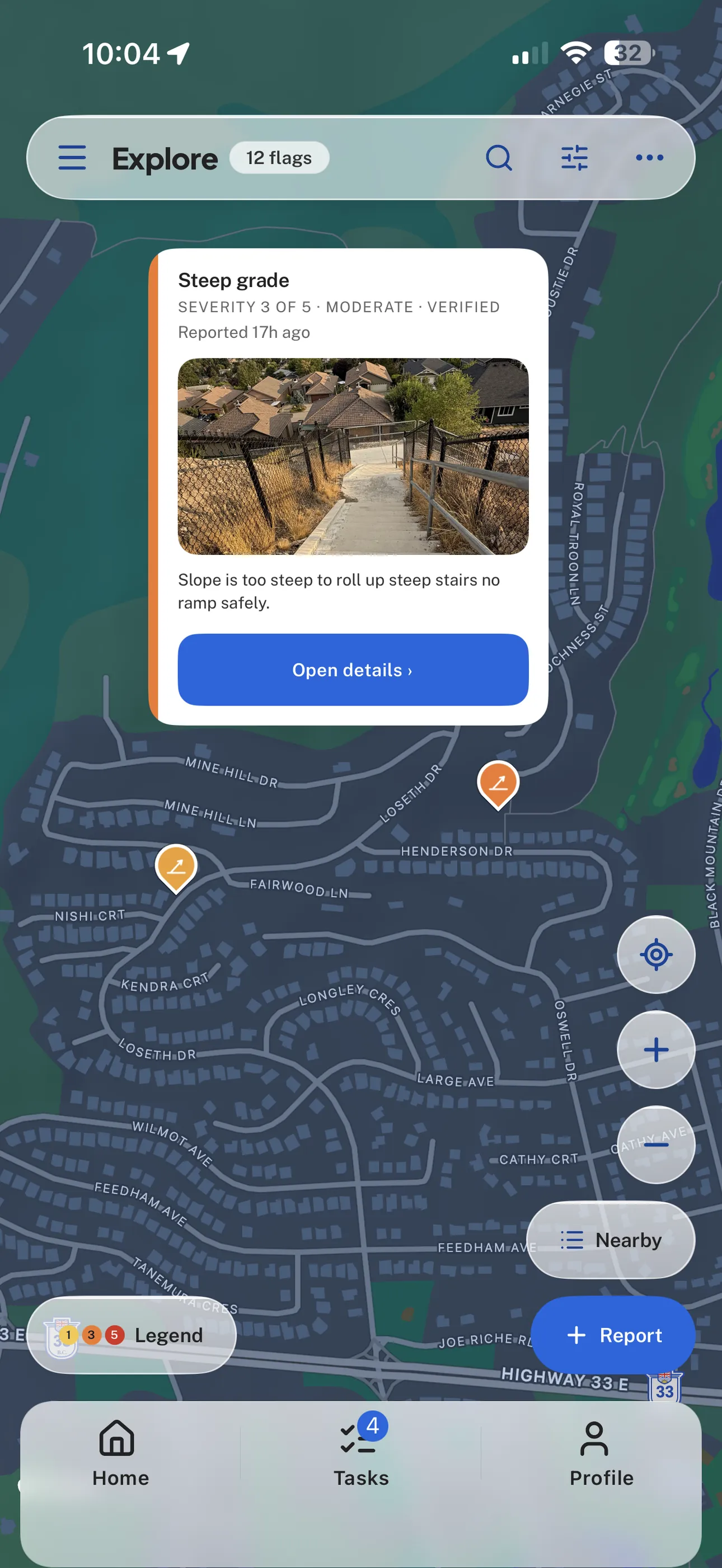 Flagstone's Explore map with an expanded verified Steep grade report, a real barrier photograph, orange map pins, map controls, and bottom navigation.