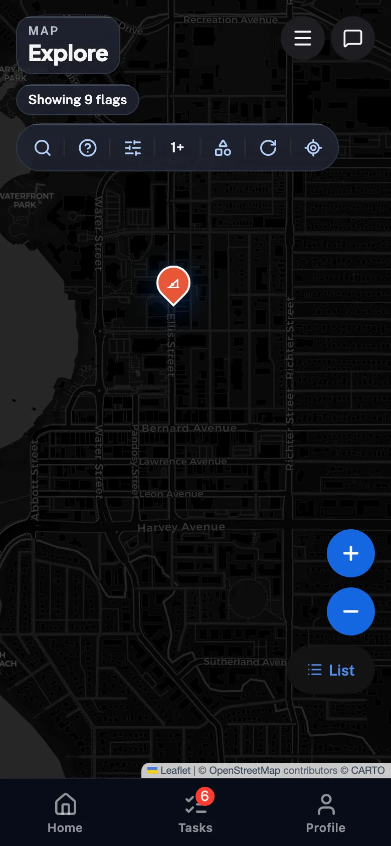 Flagstone's full map — severity-coloured barrier pins over street tiles of downtown Kelowna, a nearest-barrier banner up top and rounded zoom controls at the edge.